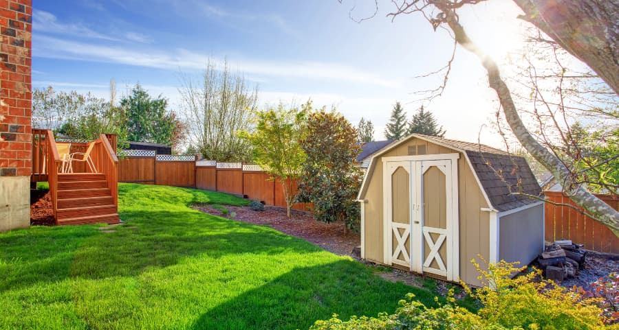 Fenced backyard with storage shed in Mobile